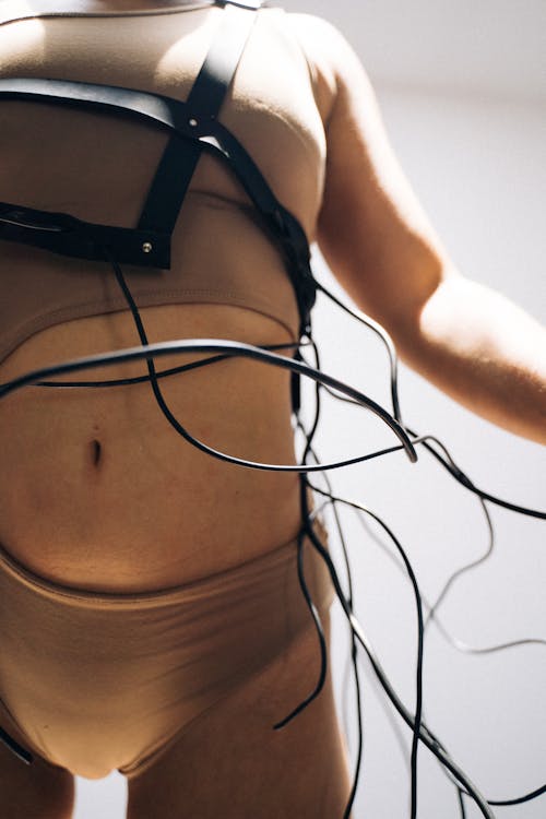 Woman Wearing a Bodysuit with Wires on Body