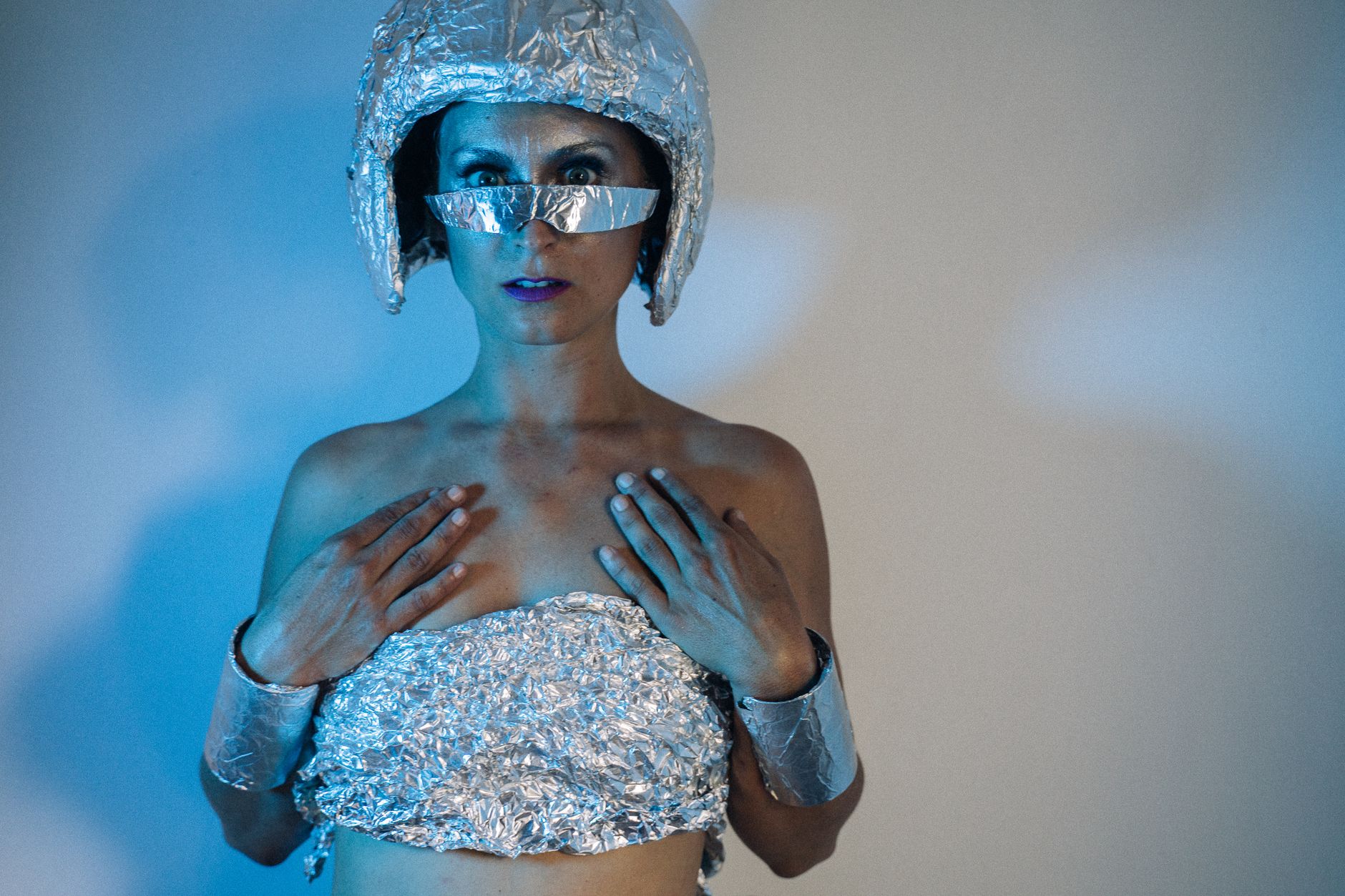 Woman posing in a sci-fi inspired foil outfit with a futuristic vibe.