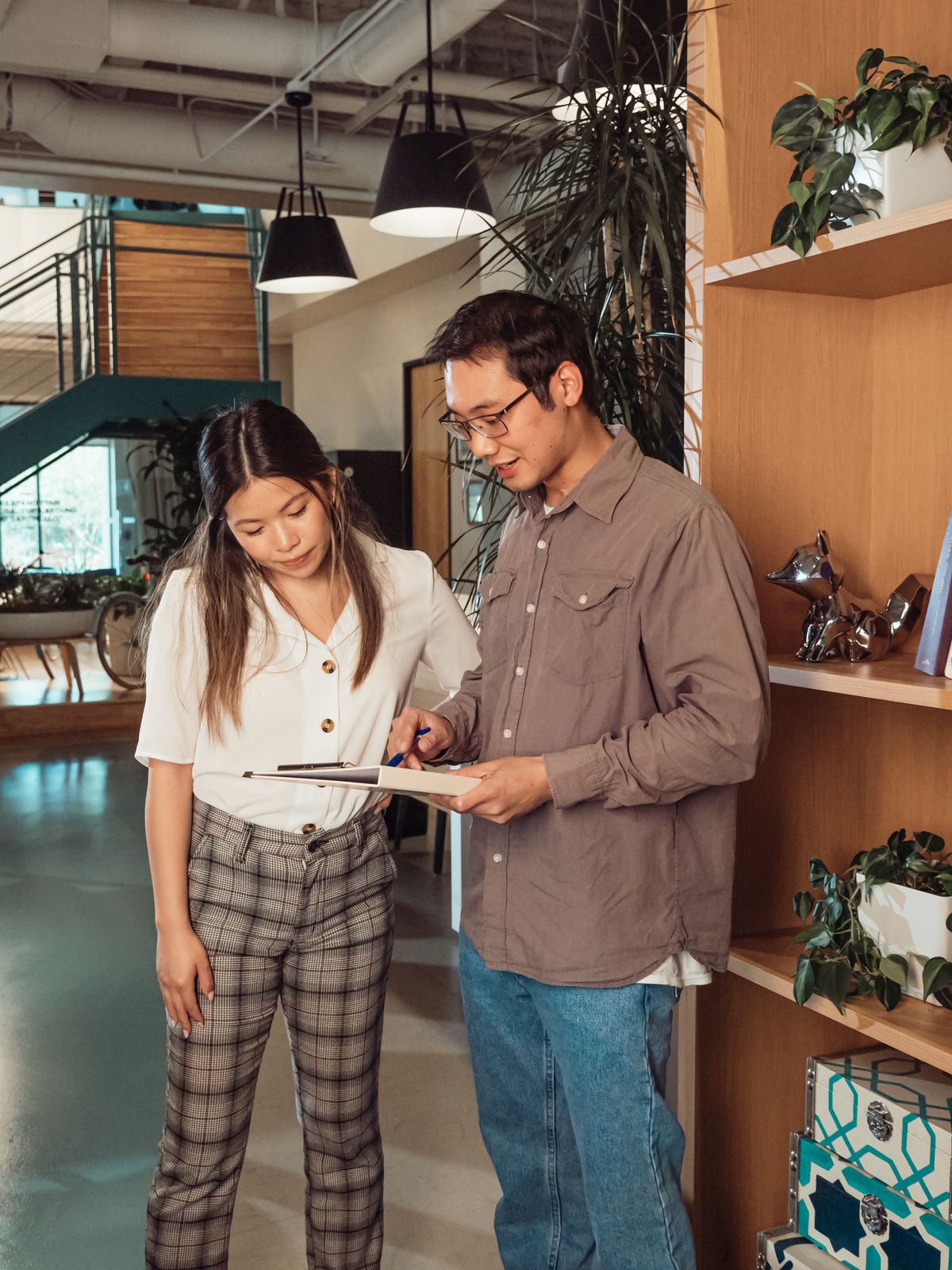 GEO agency in Gurugram: two business colleagues reviewing AI search strategy in a modern office