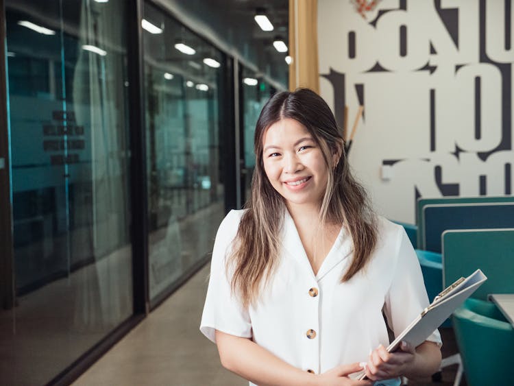 Woman Holding A Binder At The Office