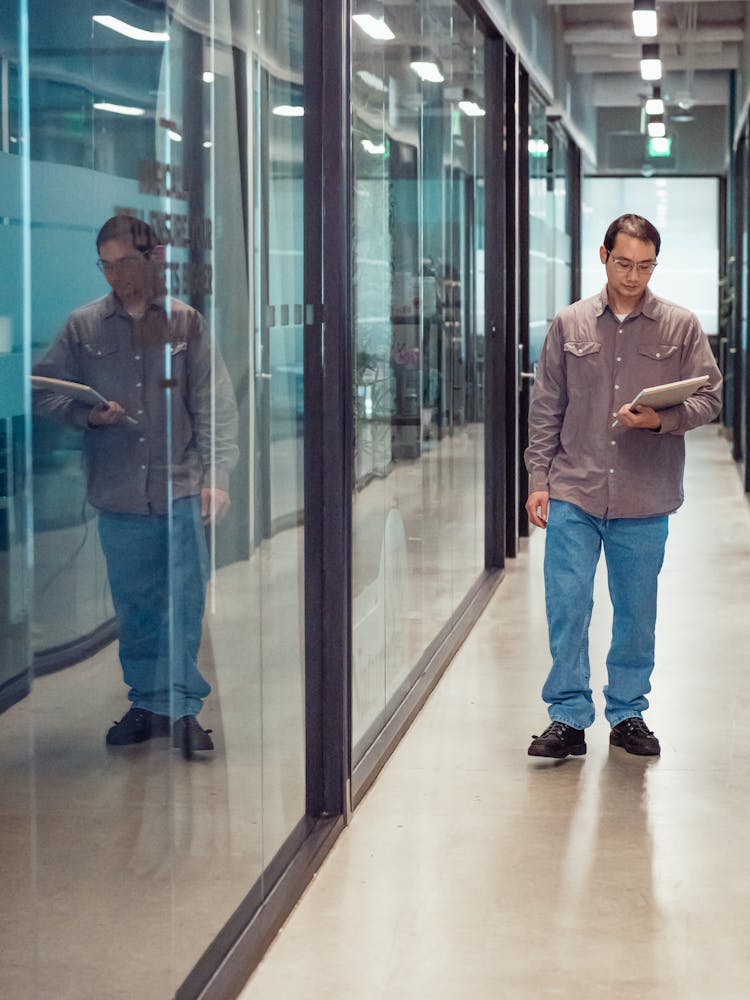 Man In Gray Long Sleeve Shirt Walking In The Office