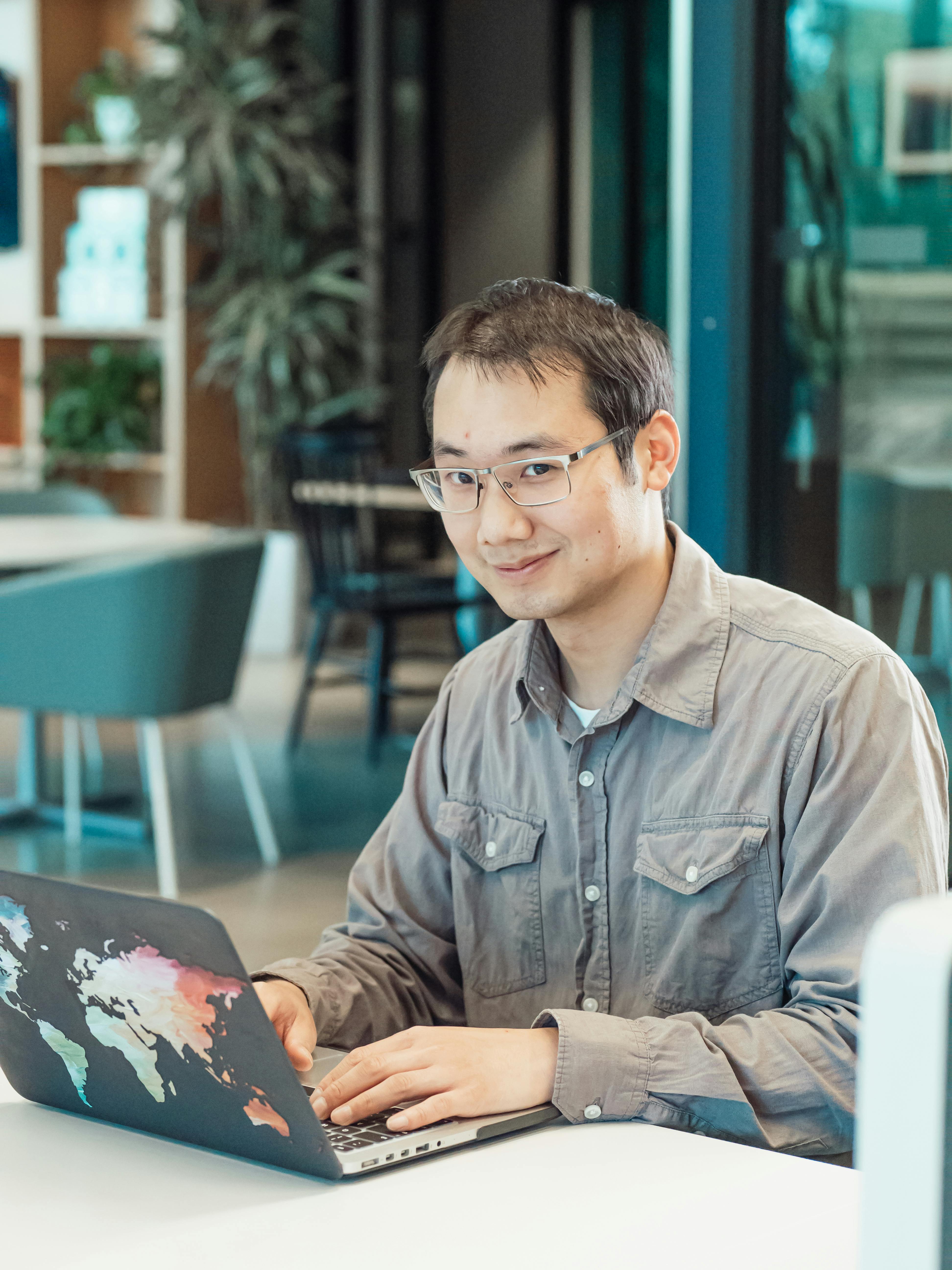 a man in gray sleeves using a laptop