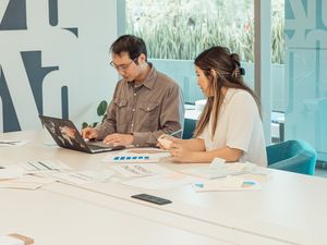 Two organisers working at a check-in desk — photo by Kindel Media on Pexels