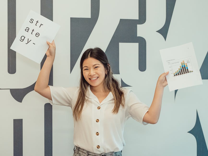 7 YouTube Shorts AI Mistakes Creators Still Make Smiling young woman in office holding business strategy documents, embodying enthusiasm and growth.