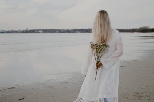 Back View of a Woman Holding Flowers