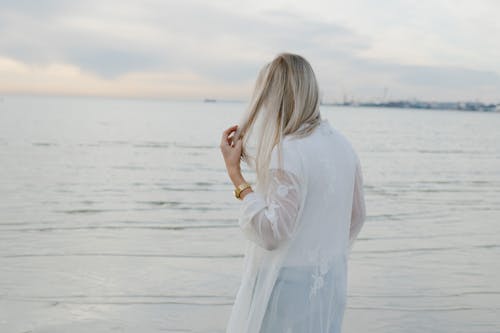 Back View of a Woman Standing on Beach