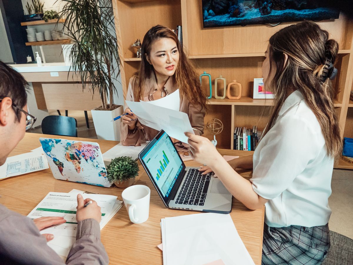 Multilingual advisory team meeting clients in a modern office