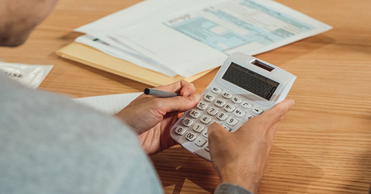 Calculator and financial documents on a household budget desk