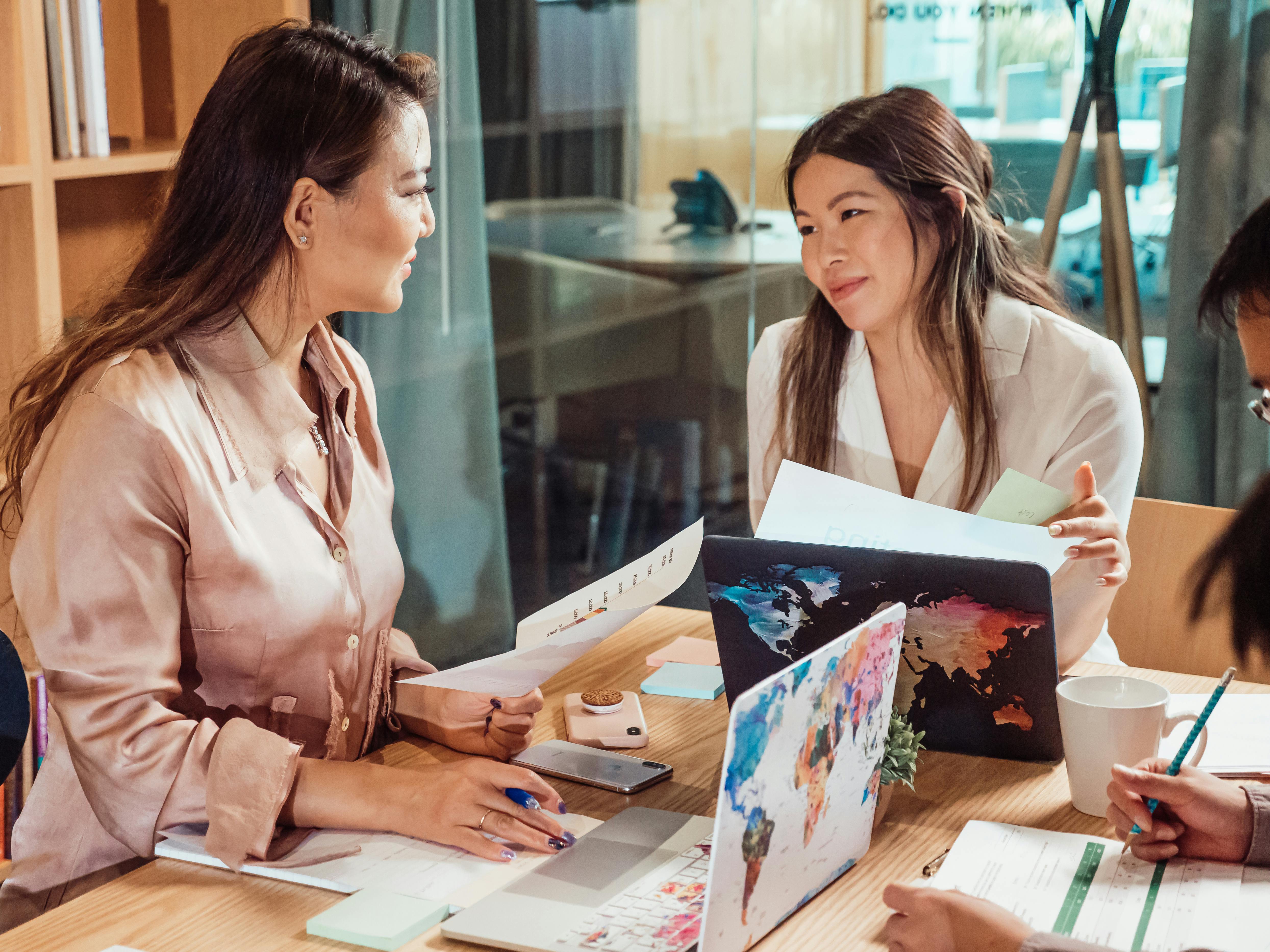 a group of people having a meeting in the office