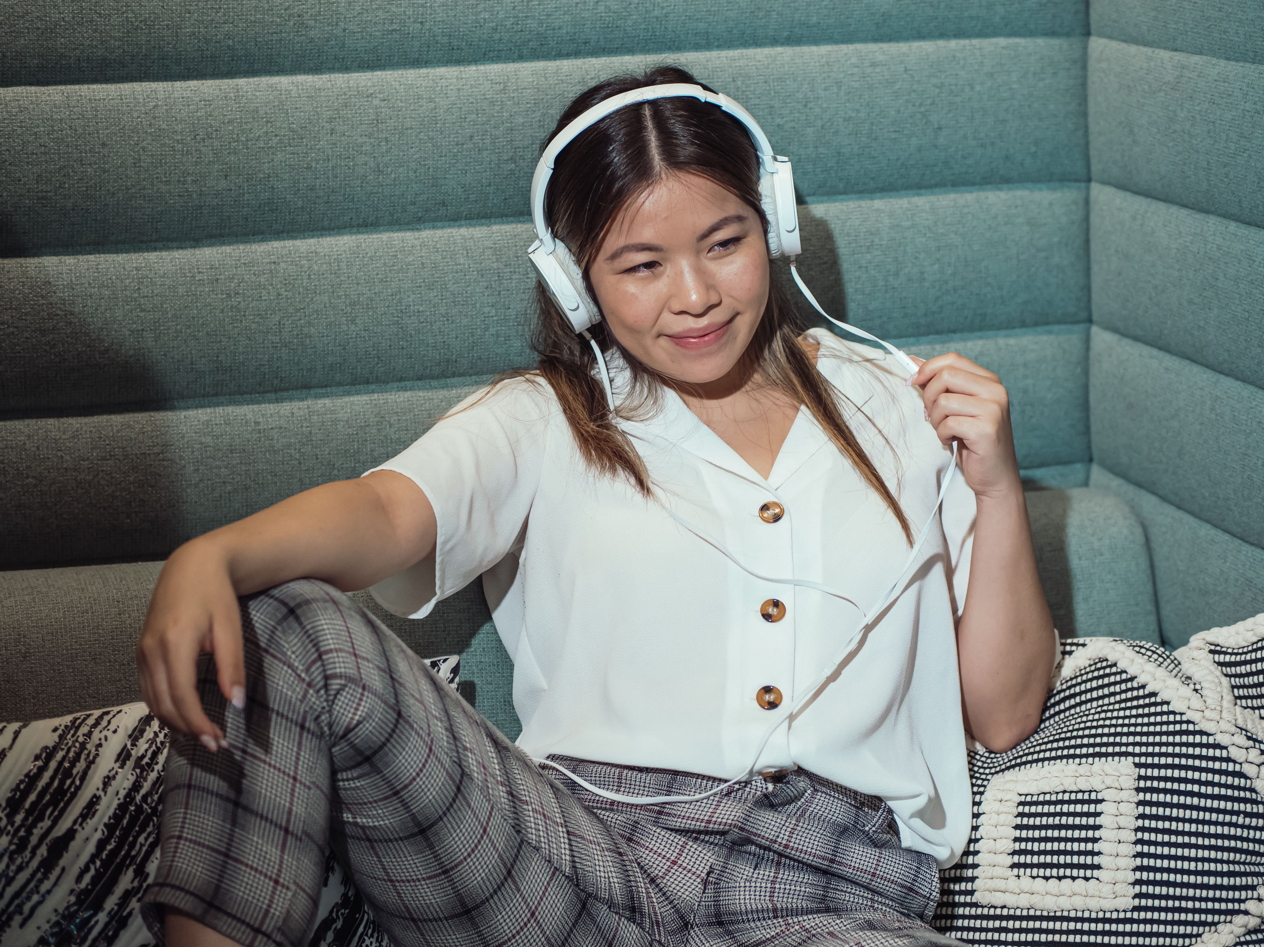 woman-in-white-button-up-shirt-and-black-and-white-plaid-skirt-sitting