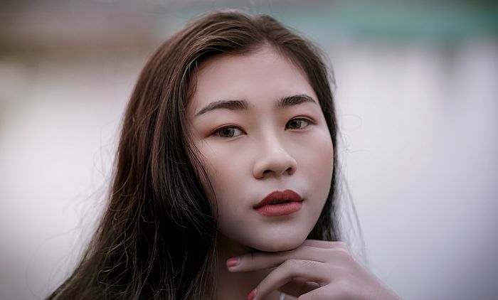 Customer close-up with red lipstick and glowing skin