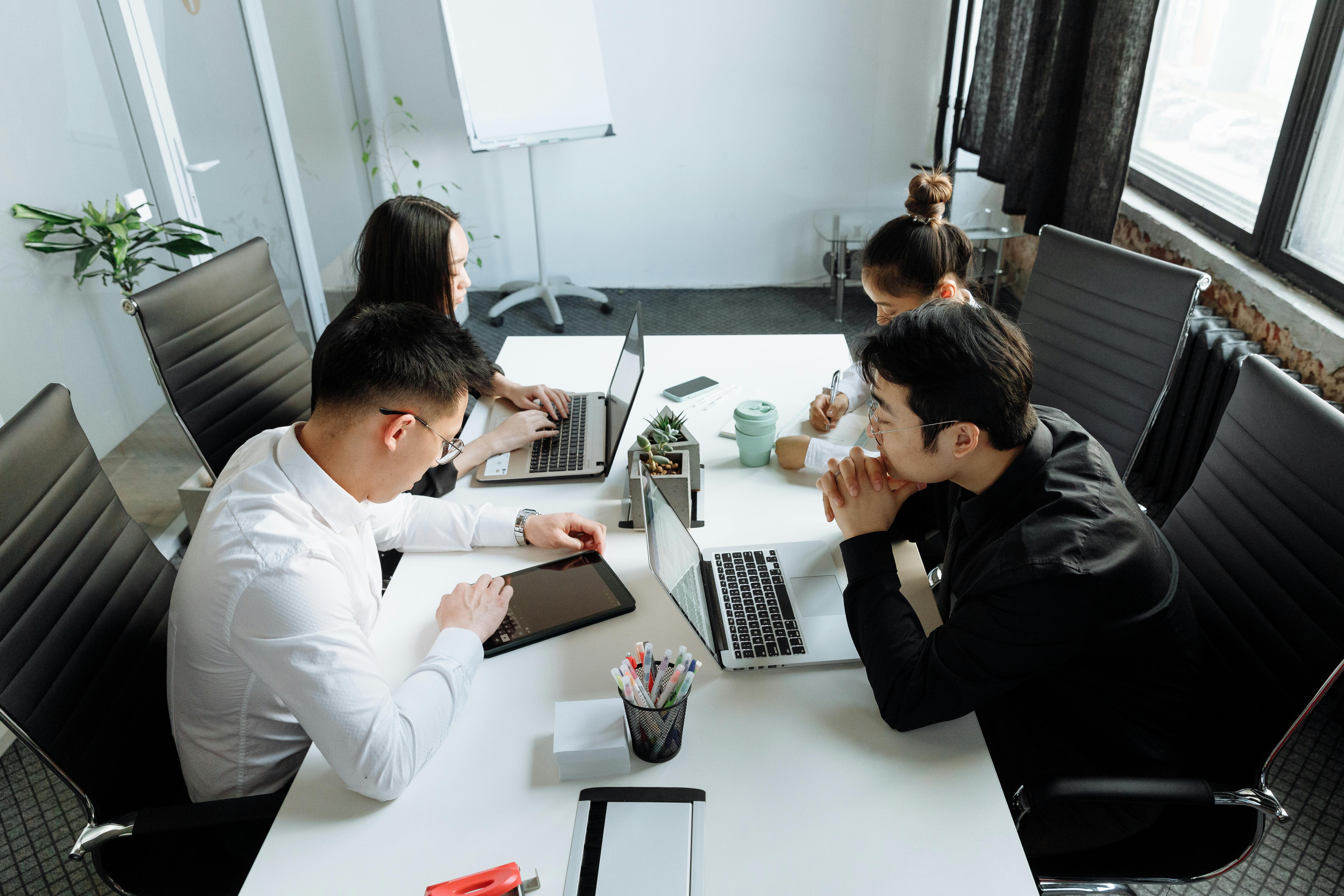 a group of people having a meeting in the office