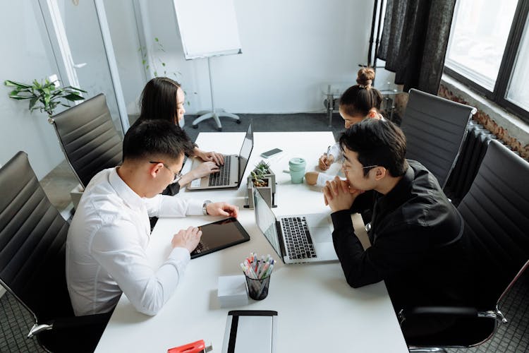 A Group Of People Having A Meeting In The Office