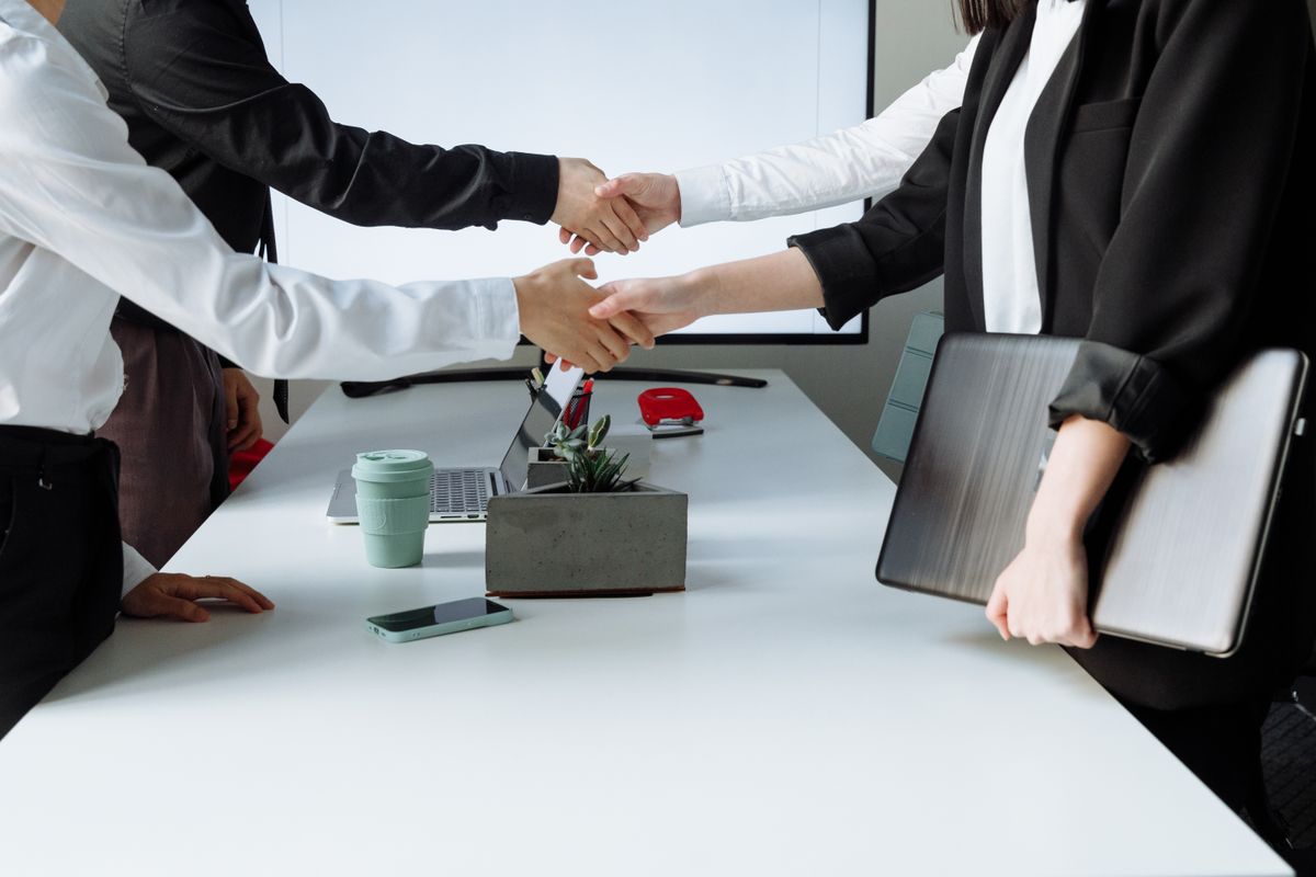 Professionals sealing a partnership at a conference table