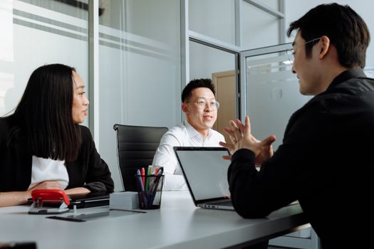 Business professionals engaged in a discussion at a contemporary office setting.