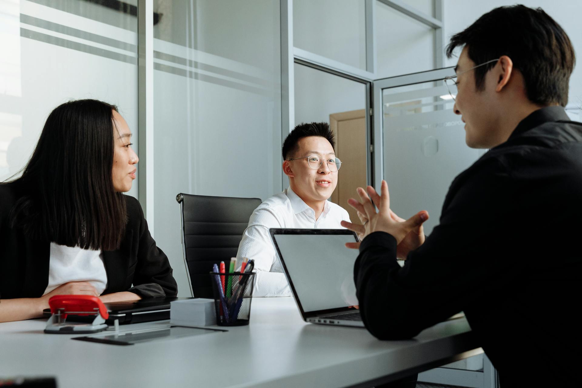 Business professionals engaged in a discussion at a contemporary office setting.