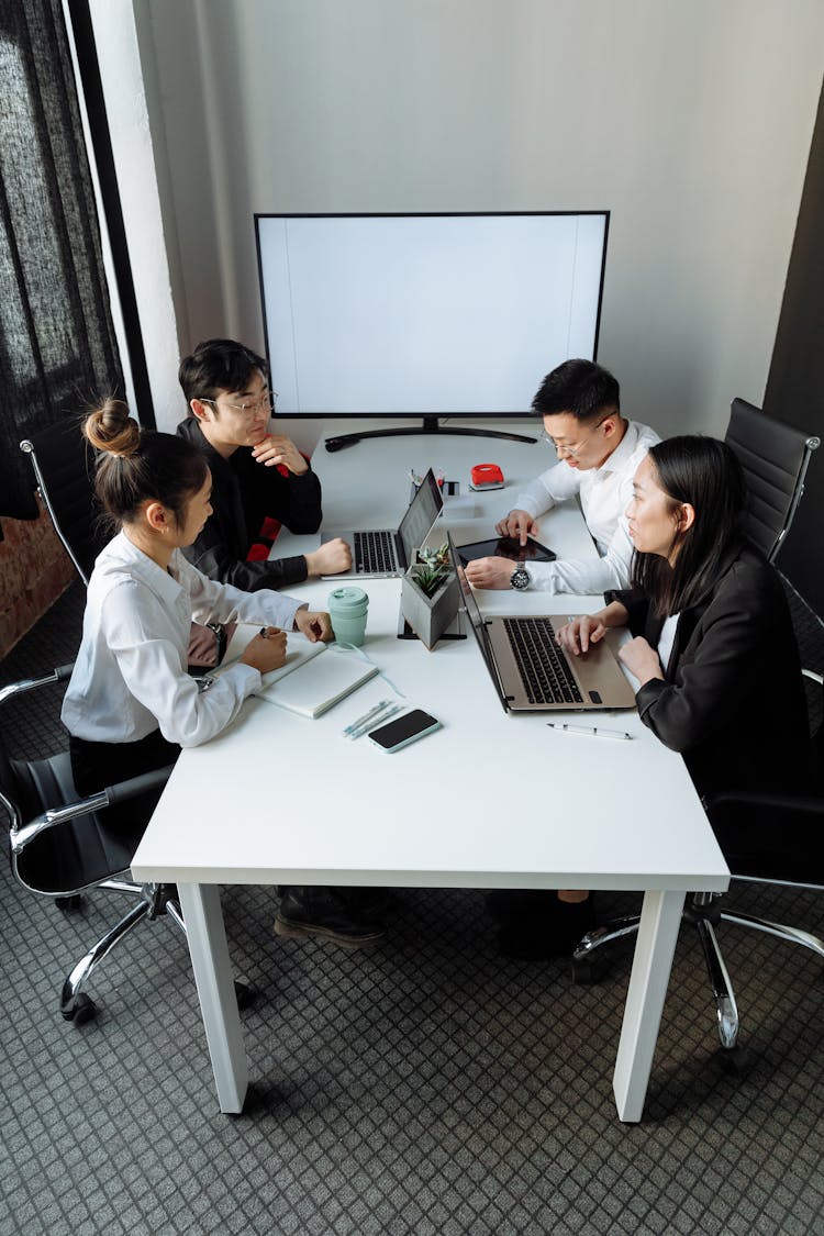 A Group Of People Having A Meeting In The Office