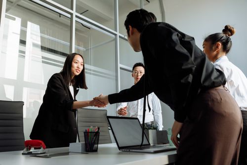 Free Group of business colleagues shaking hands during an office meeting. Stock Photo
