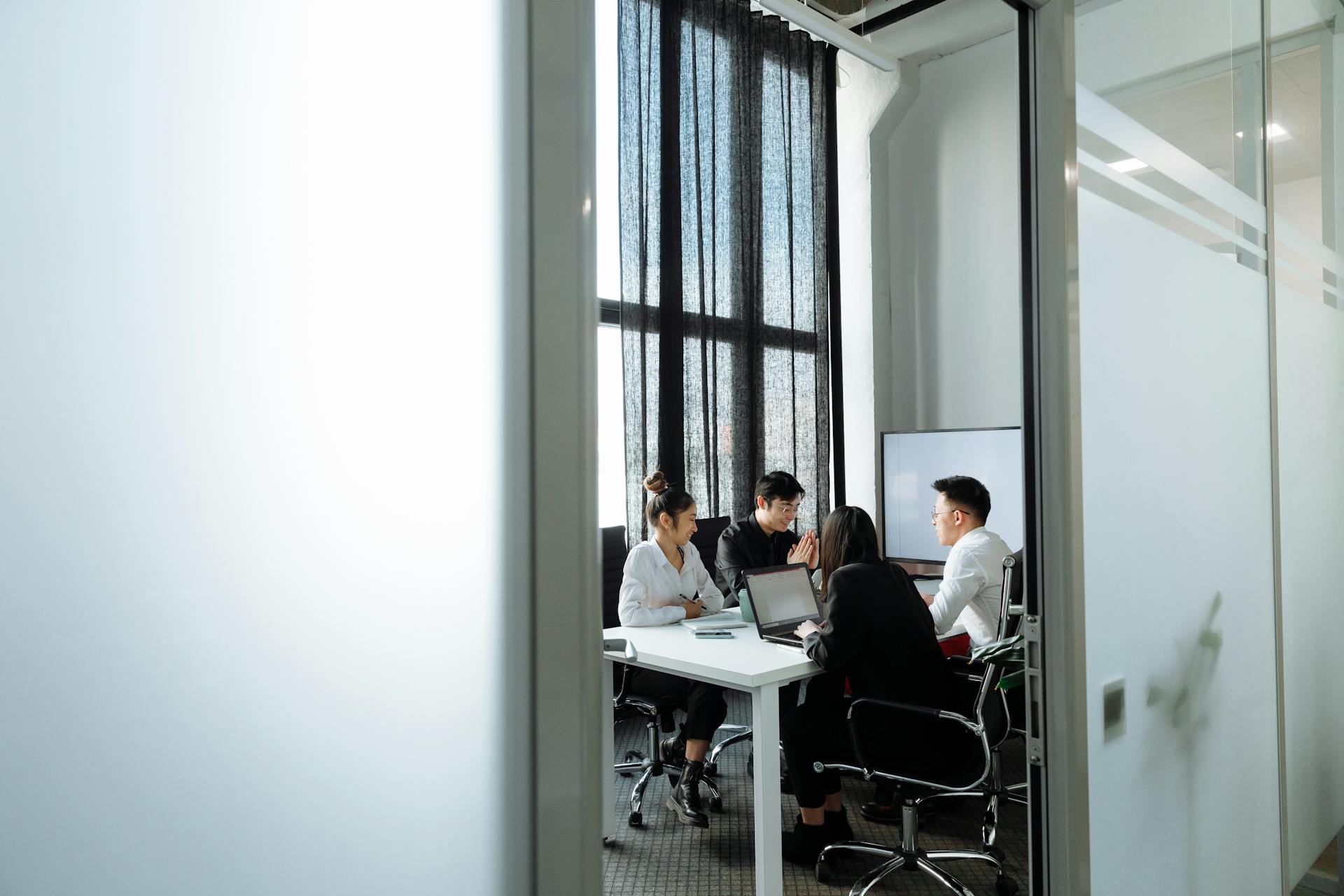 A Group of People Having a Meeting in the Office