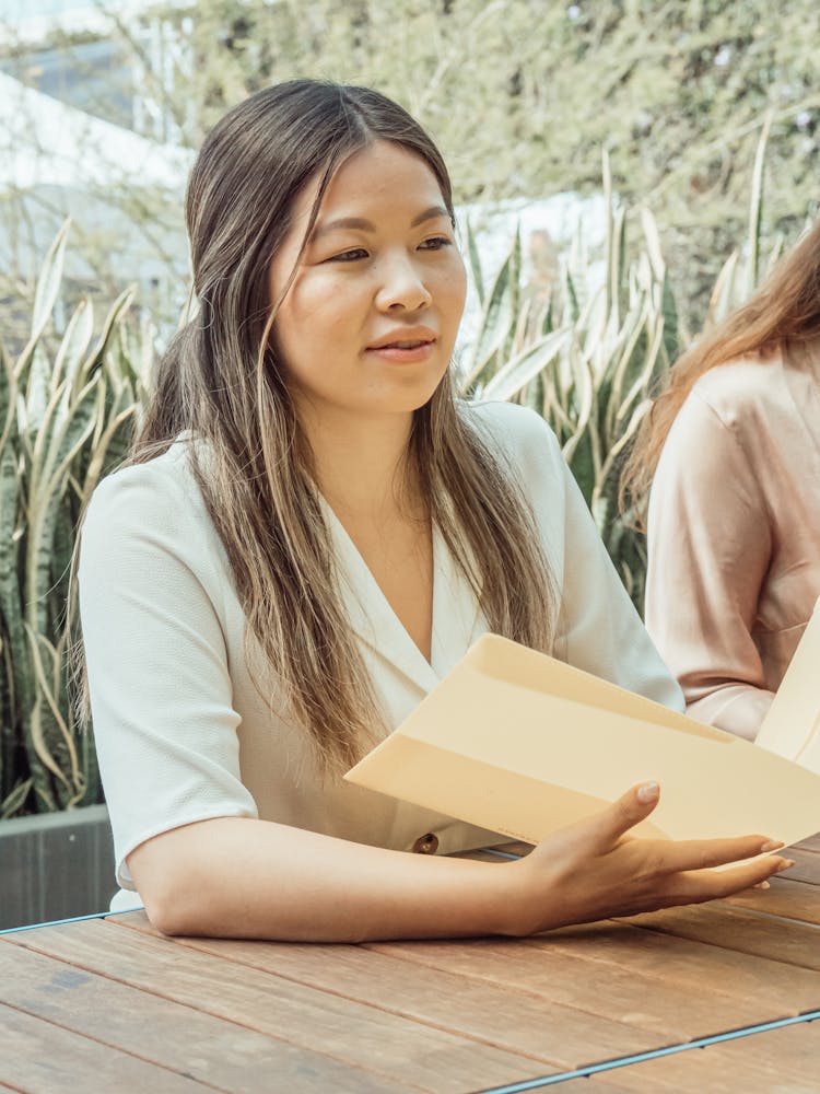 Photo Of A Woman Holding A Folder