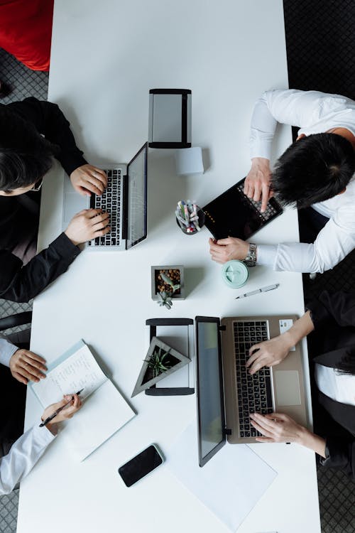 Free Overhead Shot of a Group of People Having a Meeting  Stock Photo