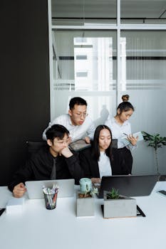 A diverse group of professionals working together in a contemporary office setting.