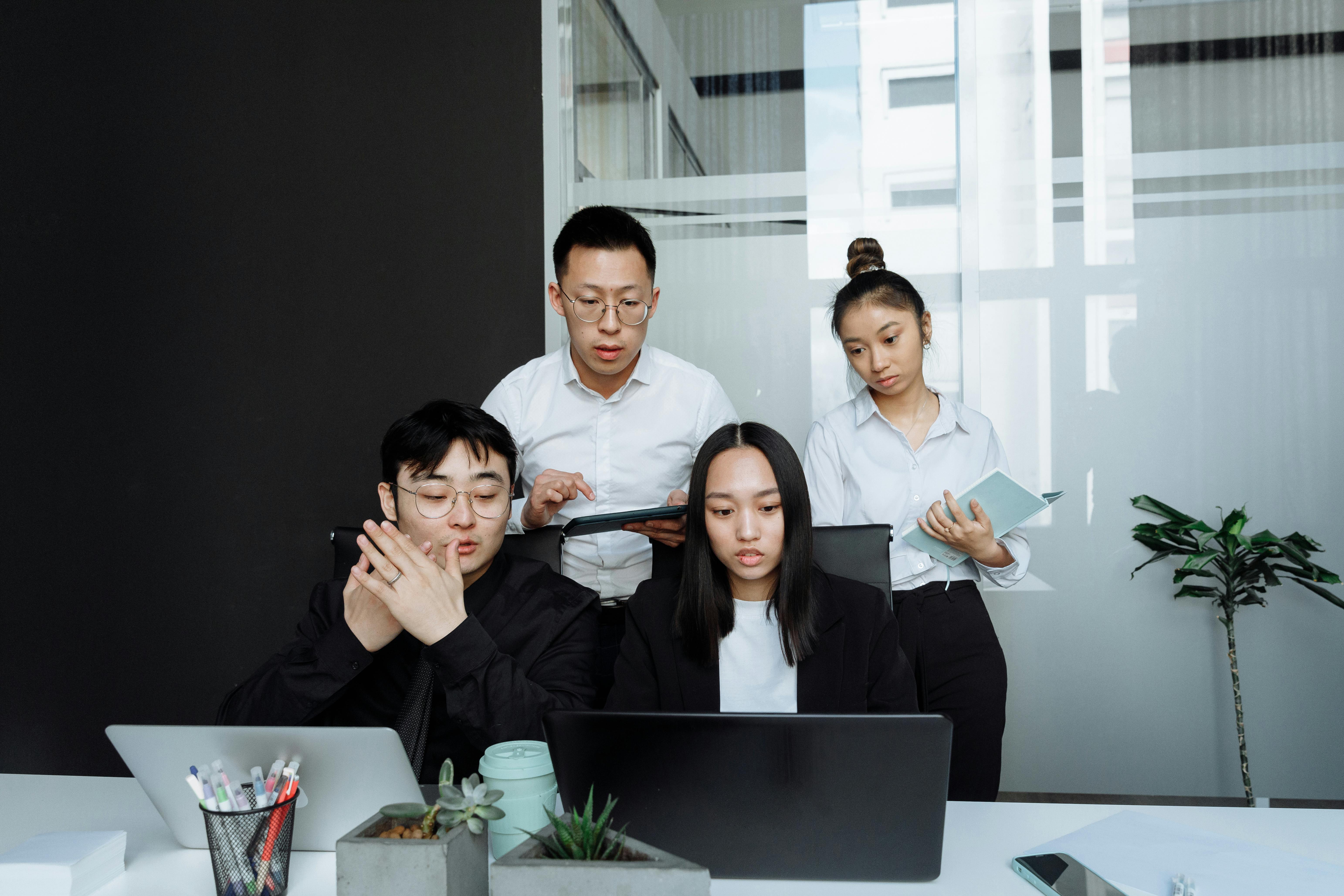 a group of people having a meeting in the office