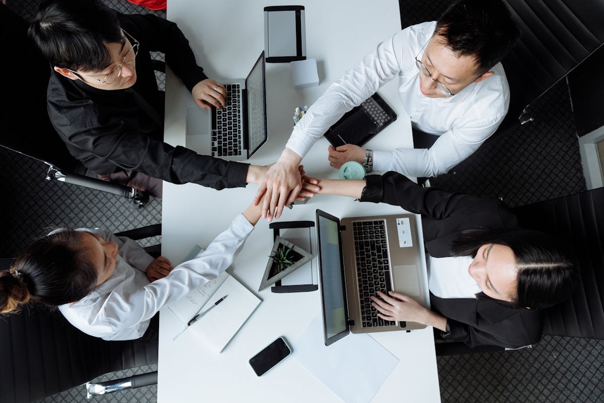 Person comparing different software options on a laptop and taking notes