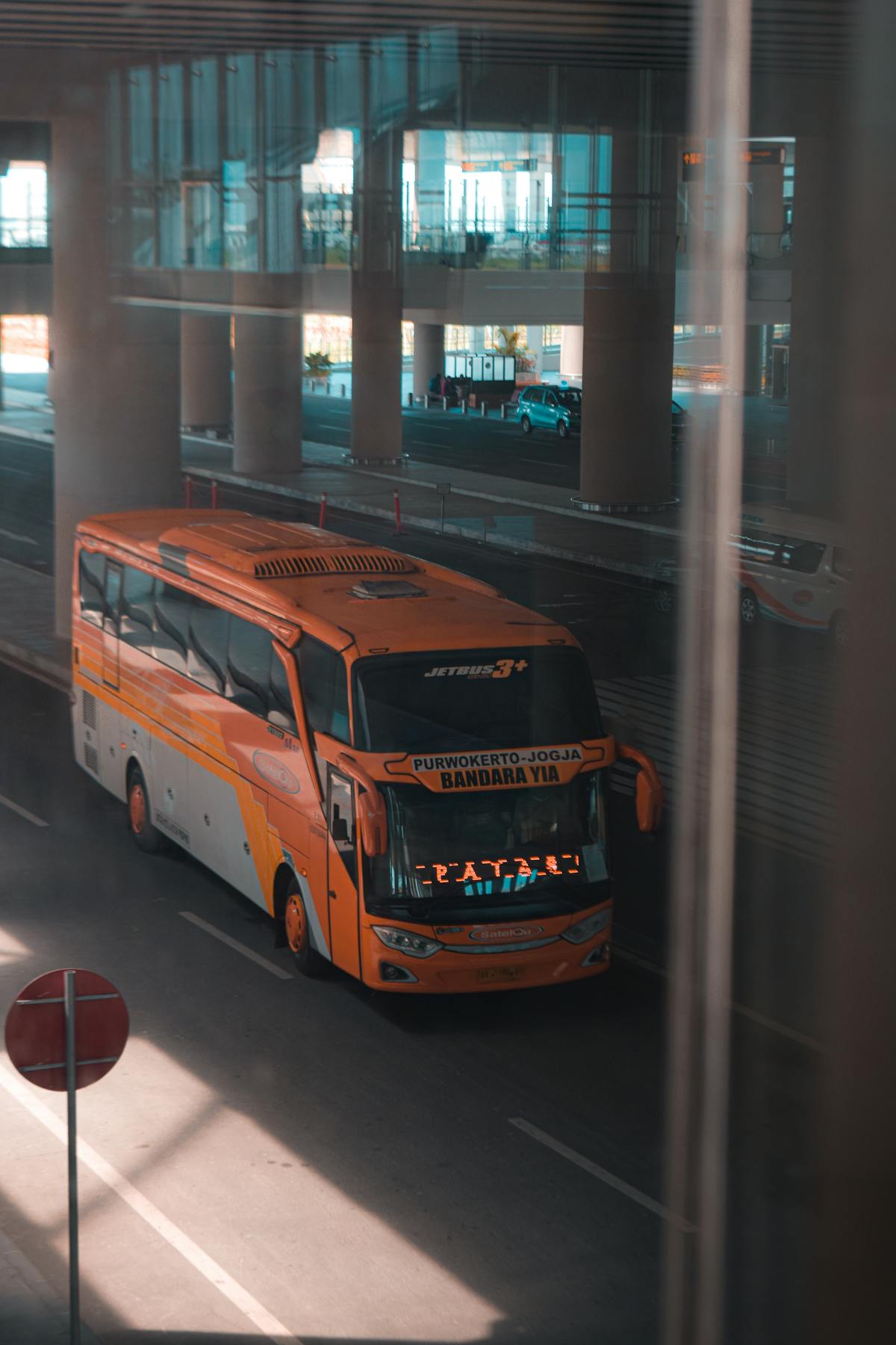 Student watching short educational videos on laptop while studying with books