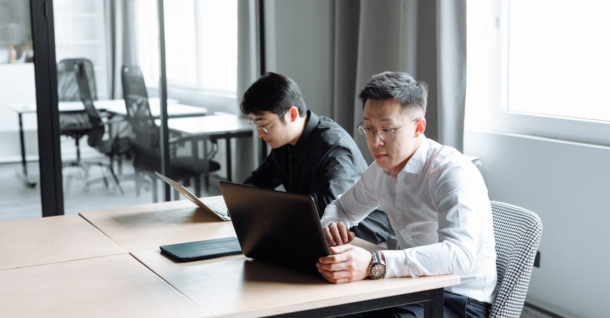 Men Sitting While Using Laptop · Free Stock Photo