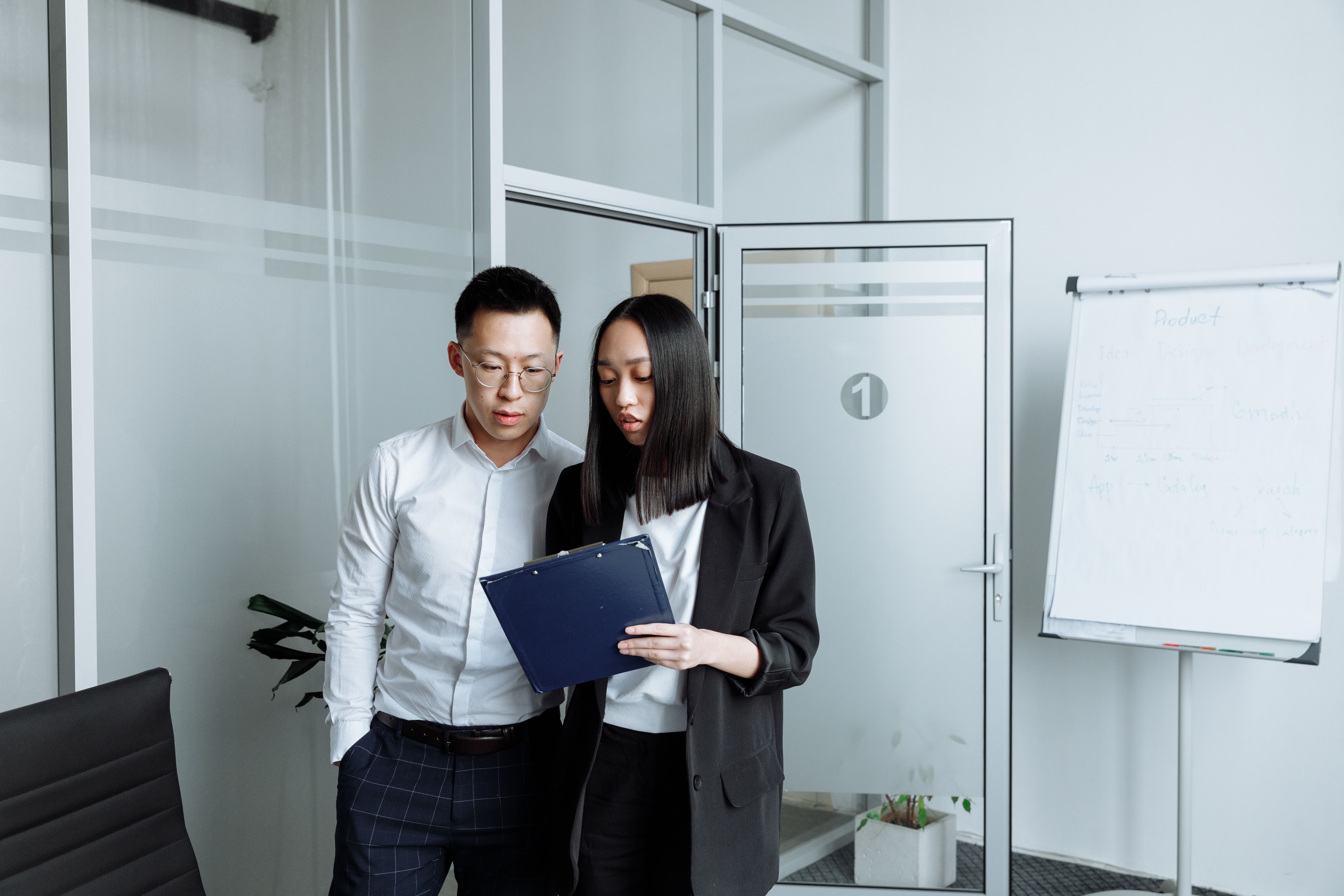 Business partners in a Houston office reviewing a contract