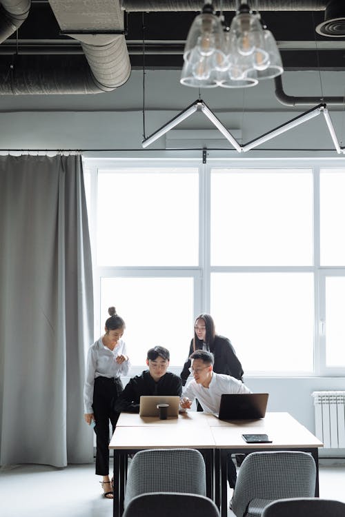 People Looking at the Screen of a Laptop