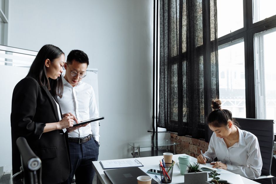 Professionals collaborating in a modern office environment, focusing on planning and teamwork.