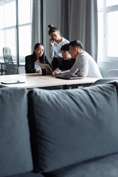 A diverse group of colleagues brainstorming together in a modern office setting.