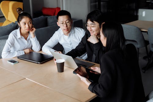 A Group of People Having a Meeting in the Office