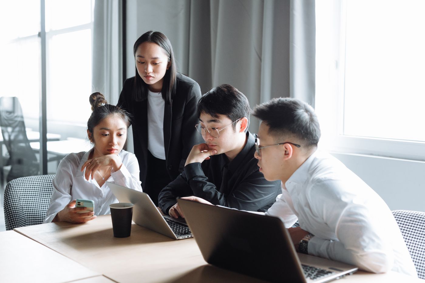 Asian team collaborating in a bright office meeting