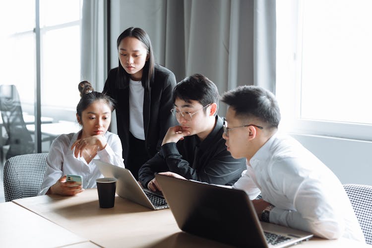 A Group Of People Having A Meeting In The Office