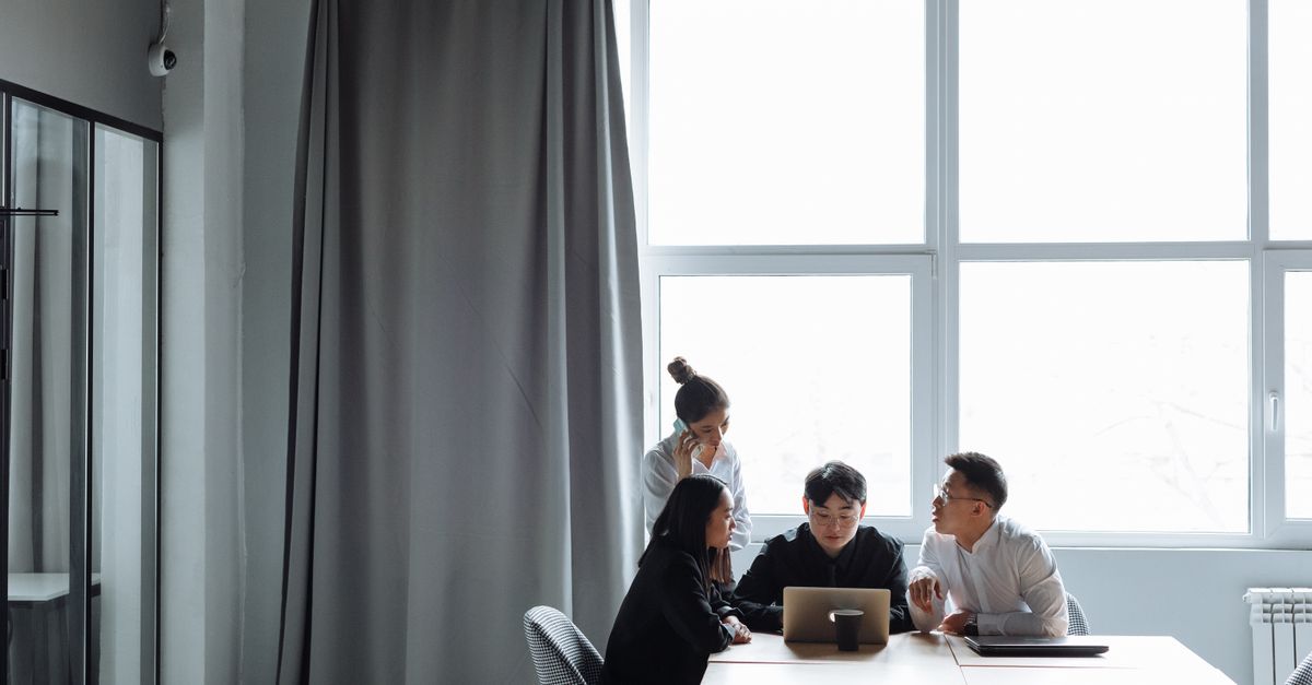 Group of diverse professionals collaborating in a modern office setting.