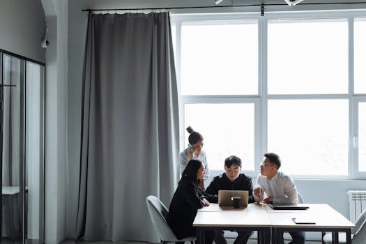 Group of diverse professionals collaborating in a modern office setting.