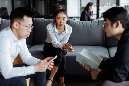 Free Three young adults engaged in a collaborative business meeting indoors. Stock Photo