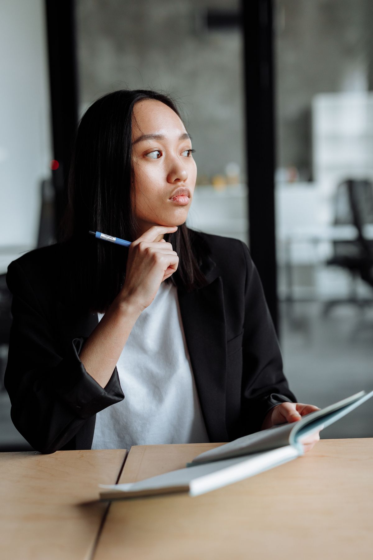 Thoughtful person reflecting on whether they have the traits to become an AI consultant