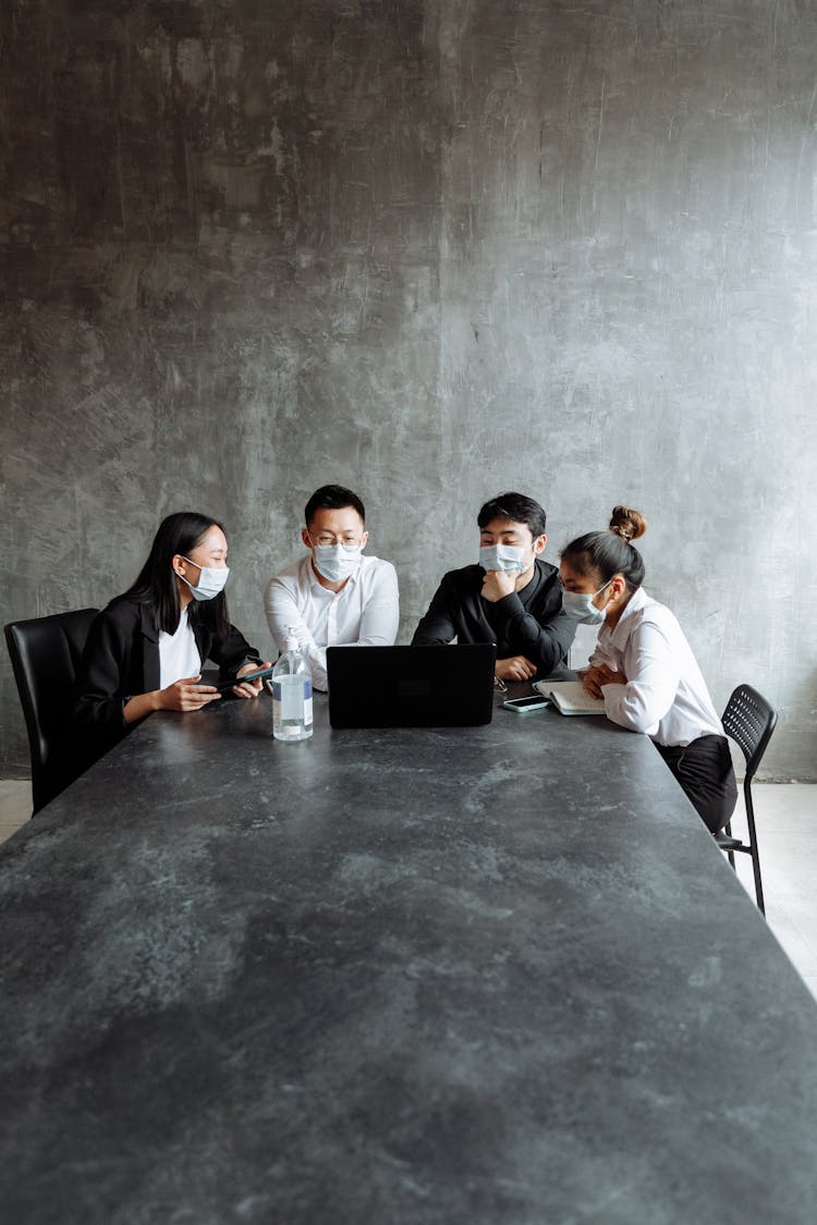 Group Of People Having A Discussion On Gray Table