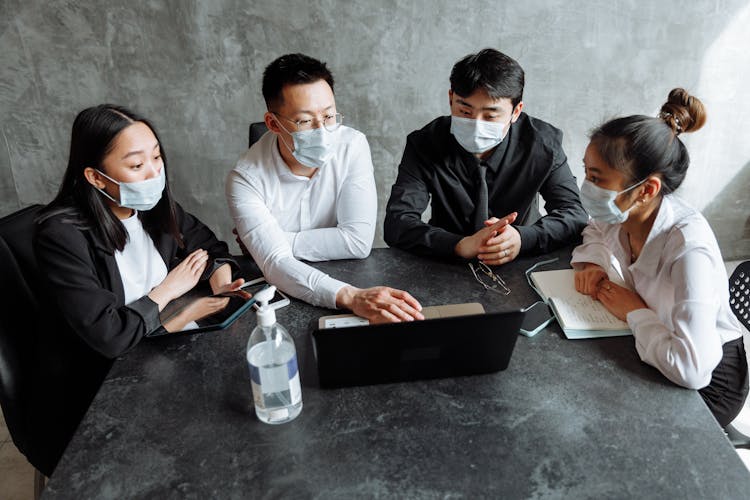 Colleagues Wearing Face Masks Having A Discussion