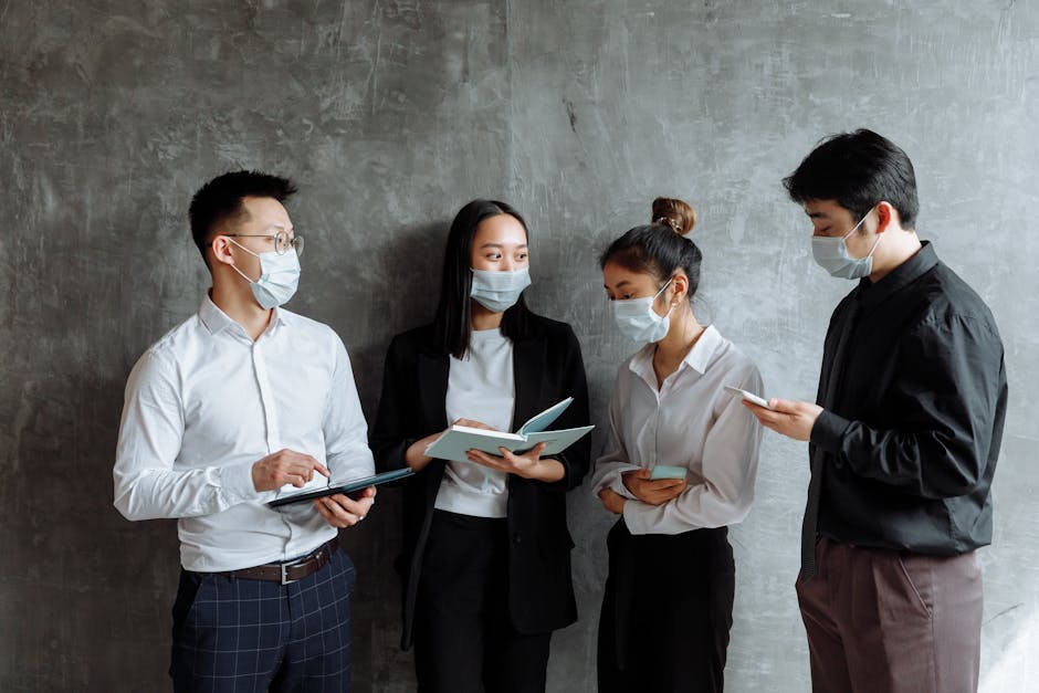 People Wearing Face Mask Standing beside Gray Concrete Wall