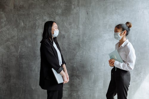 Young Women in Business Attire Wearing Facemasks
