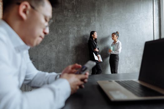 Business professionals engaged in a conversation in a contemporary office setting.