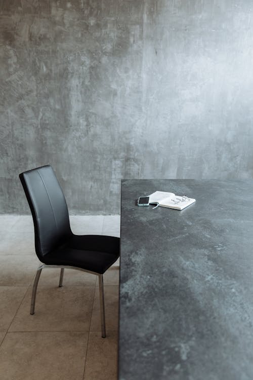 Free A Black Chair beside a Table Stock Photo