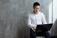 Man in White Long Sleeve Shirt Using Laptop