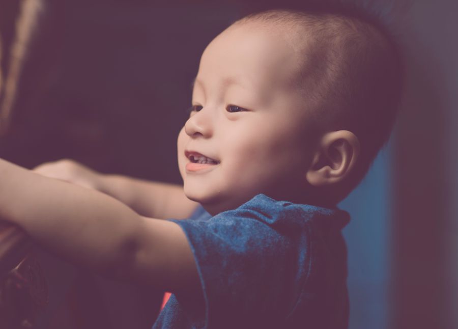 Close-up of a smiling baby in soft warm light