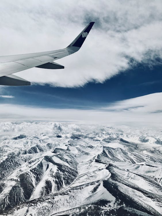 A View of Snow Covered Mountains from an Airplane · Free Stock Photo